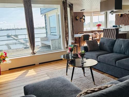 a living room with a couch and a table at Weromerie Premium Hotel and Apartment in Wormer