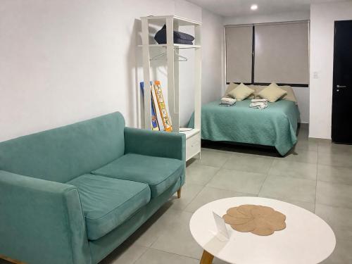 a living room with a couch and a bed and a table at México 1510 - Neuquén Centro in Neuquén