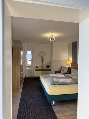 a bedroom with a bed and a desk in a room at Hellwig Ferienwohnung 5 in Bernburg