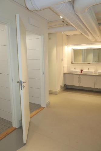 an empty room with a sink and a bathroom at Kville Hostel in Gothenburg