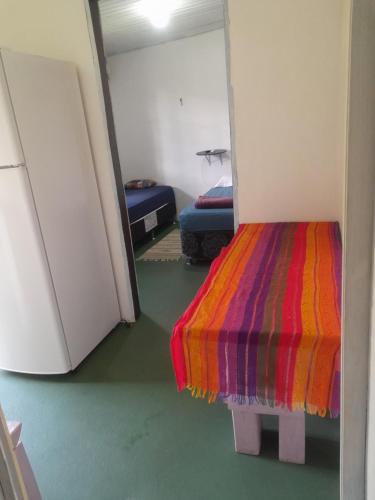 a room with two beds and a colorful blanket at Nosso Lar in Porto Velho