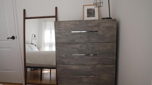 a dresser with a mirror next to a bedroom at The Heights Haven, Spacious 6 Bedrooms Townhouse with Patio in New York