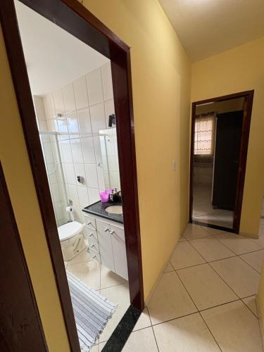 a bathroom with a sink and a mirror at Apartamento do Lala in Arraial do Cabo