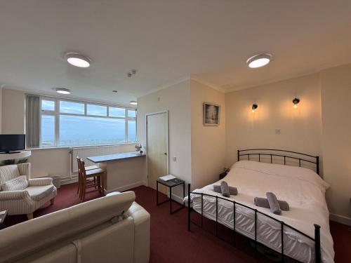 a bedroom with a bed and a living room at Apartment 2 Maritime House in Portland