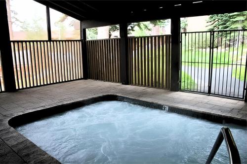 a large swimming pool in a screened in backyard at The Icelander at Mammoth Point in Mammoth Lakes