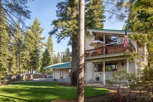 a house with a balcony and a yard at Sandy Shores Villa in Tahoe Vista