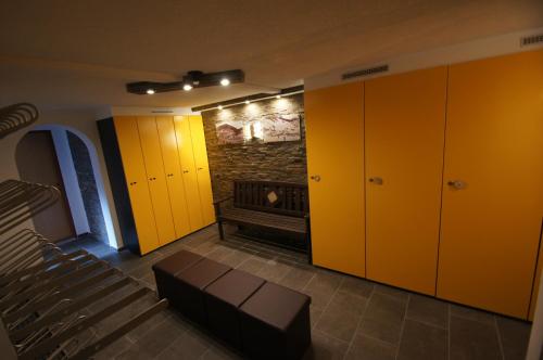 a room with yellow lockers and a fireplace at Haus Eder Steiner in Saalbach Hinterglemm
