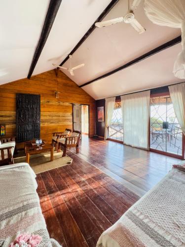 a living room with wooden walls and wooden floors at Lodge Océan et Savane in Saint-Louis
