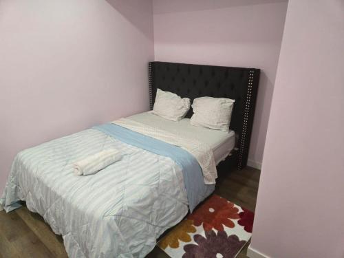 a small bedroom with a bed with two pillows at Bedroom in the basement Upland F in Edmonton