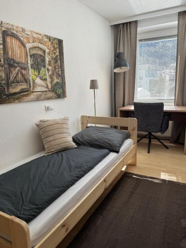 a bedroom with a bed with a painting on the wall at Mary's Wohlfühlapartment in Landeck
