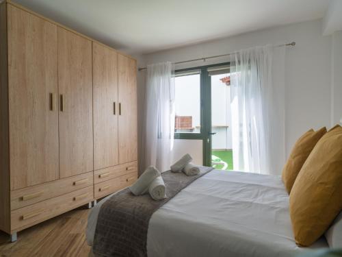 a bedroom with a large bed and a large window at Aguadulce Agaete 1A in Agaete