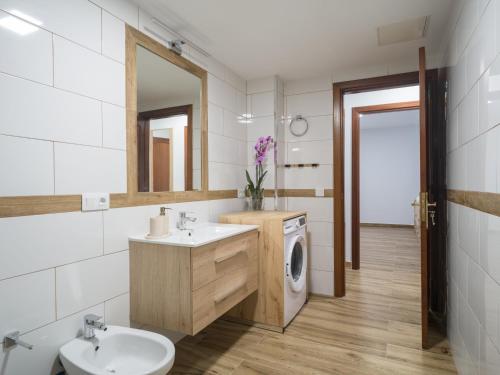 a bathroom with a sink and a washing machine at Aguadulce Agaete 1B in Agaete