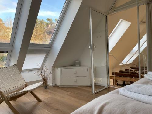 a bedroom with a glass shower in a attic at Seedorf Hideaway, Reethaus mit Garten und Privatsteg, Kamin, Sauna und Hot Tub in Ostseebad Sellin
