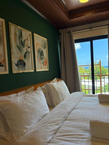 a bedroom with a white bed with a window at Ruka Maldives in Dhiffushi