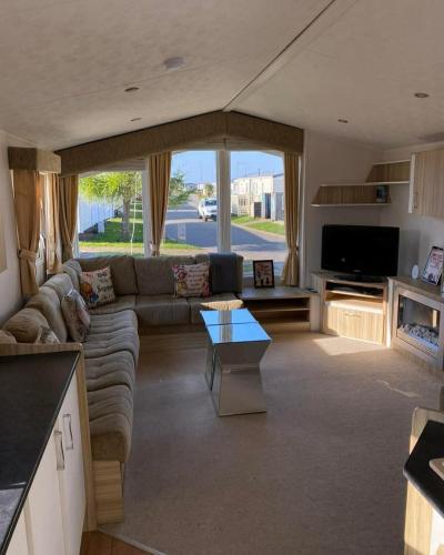 a living room with a couch and a table at Robin hood rhyl Ll18 3uu in Rhyl