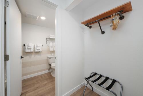 a bathroom with a toilet and a chair in it at Varsity North in Centralia