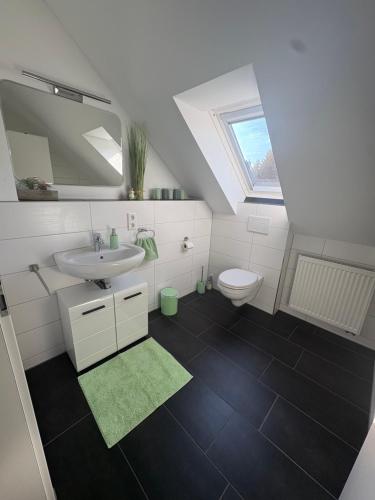 a bathroom with a sink and a toilet at Apartments Reischl in Bergkirchen
