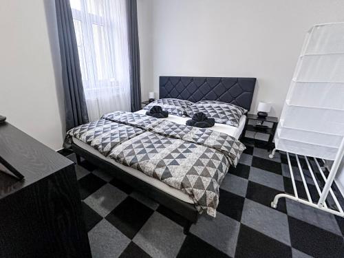 a bedroom with a bed and a checkered floor at Hotel Central in Ostrava
