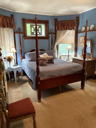 a bedroom with a canopy bed and a window at Bentley House Bed and Breakfast in Poultney