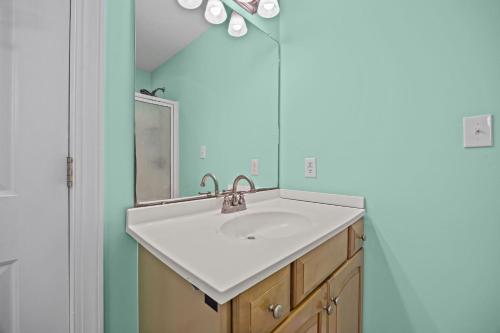 a bathroom with a sink and a mirror at Oceanwalk in Atlantic Beach