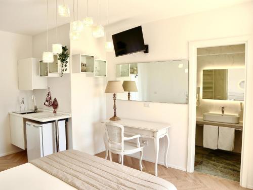 a white room with a table and a bathroom at Adagio Salentino in Porto Cesareo