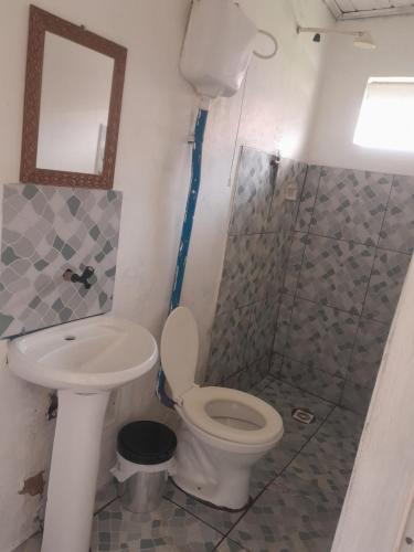 a bathroom with a toilet and a sink and a shower at Guardião in Porto Velho