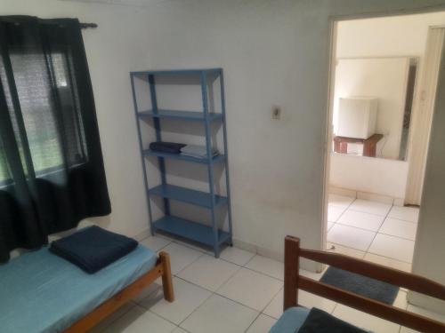 a room with a blue book shelf in a room at Guardião in Porto Velho