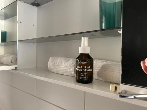a bottle of mouthwash sitting on a shelf in a bathroom at La Garçonnière in Colombier