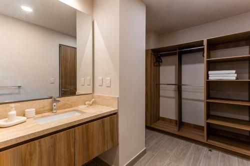 a bathroom with a sink and a mirror at Las Arenas de Cabo in Cabo San Lucas