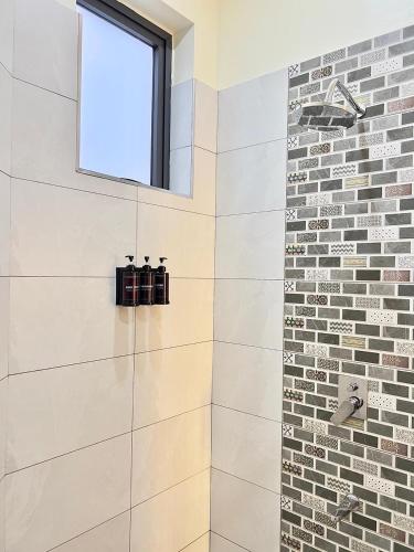 a bathroom with a shower with a window at Luxury Beachfront apartment at Baobab Waves in Mombasa