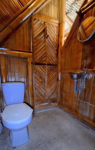 a bathroom with a toilet and a sink at Playa Escondida Mayapo in Mayapo