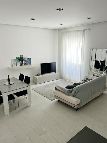 a living room with a couch and a table at AragonApartment in Santa Maria a Vico