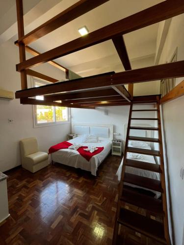 a bedroom with a loft bed and a staircase at DM Thermas Hotel Iraí in Iraí