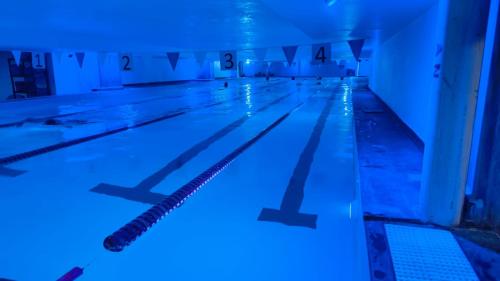 an empty swimming pool with blue lights on it at HS HOTSSON CDMX Condesa Sur in Mexico City