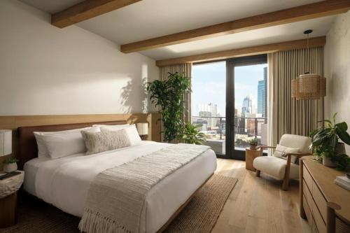 a bedroom with a large bed and a large window at 1 Hotel Austin in Austin