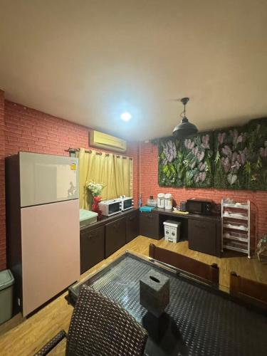 a kitchen with a white refrigerator in a room at BT fifty in Bangkok