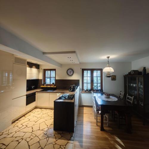 a kitchen with a table and a stove top oven at Leśny Relaks in Krasiejów