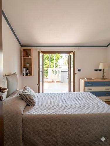 a bedroom with a bed and a door to a patio at Residence Martina in Marina di Camerota