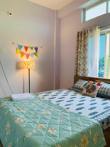 a bedroom with a bed and a window at Windchime 9 in Guwahati