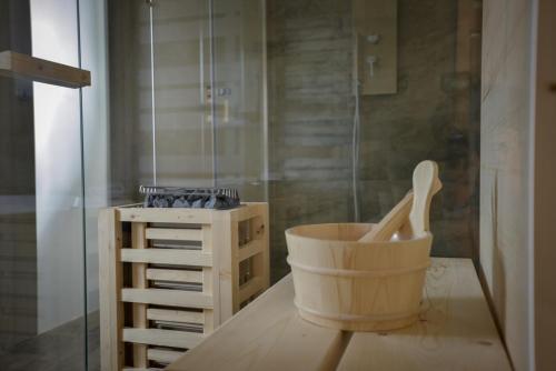 a bathroom with a wooden bucket and a shower at Tosco Suite "Ecclesia" in Sasso dʼOmbrone