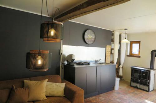 a living room with a couch and a kitchen at La maison de Barbara in Aubel
