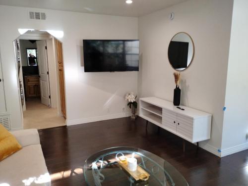 a living room with a table and a mirror at Cozy Suite near Universal Studios in Los Angeles