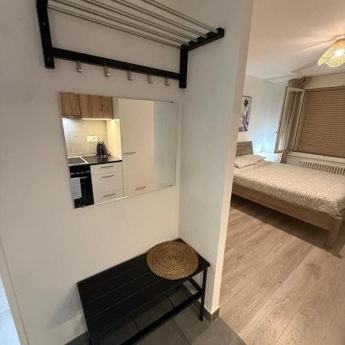 a small room with a bed and a mirror at Flor- Sakura Gare Lausanne in Lausanne