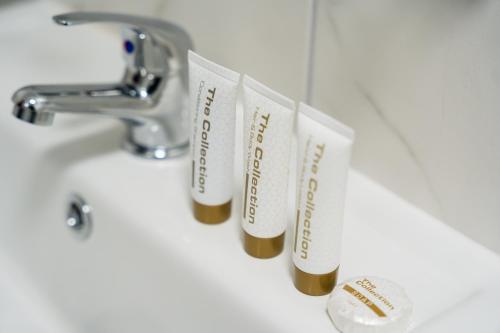 a row of toothbrushes hanging from a bathroom sink at 8 Stanley Street Apart-Hotel in Liverpool