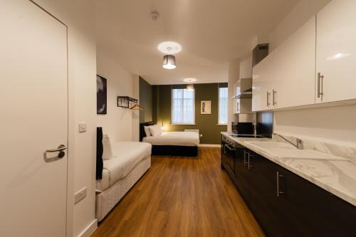 a kitchen with a couch and a bed in a room at 8 Stanley Street in Liverpool