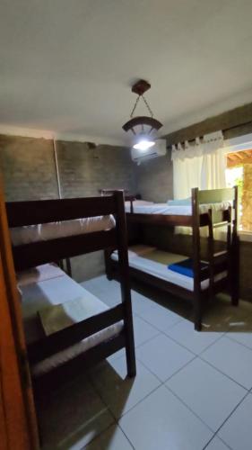 a bedroom with two bunk beds and a window at Sitio Mãe Rainha in Petrolina