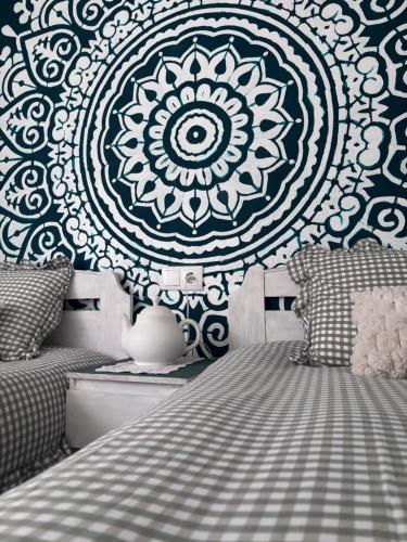 a bedroom with a blue and white mandala wall at Henko-Alloza in Alloza