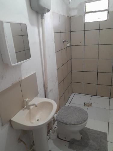 a bathroom with a toilet and a sink at Fênix in Porto Velho