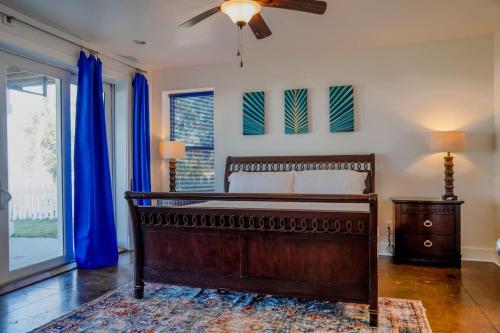 a bedroom with a bed and a ceiling fan at Salty Bay Hideaway in Gulf Breeze