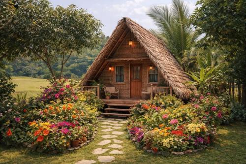 a small cabin with flowers in front of it at Calmira Boutique Stay in Kegalle